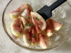 いちじくとタイムの葉をゴムベラで和える様子
